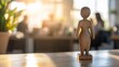 © aan - Wooden Figure on Table with Office Background.