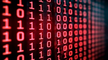 Close-up view of red binary code on a screen, showing digital data and programming