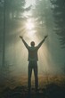 © Irina - Man standing in forest with raised arms toward sunlight through mist