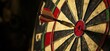 © Vergiliy - dart hitting bullseye on dartboard with vibrant colors and detailed texture