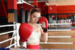 © New Africa - Woman with protective gloves on boxing ring