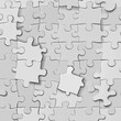 © Ikram - A pattern of many light gray jigsaw puzzle pieces.  A few pieces are slightly out of place