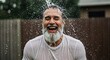 © DEGE - Joyful Man Experiencing Water Shower Refreshment Laughing Outdoors with Happiness and Positive Vibes