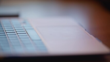 Wall Mural - Finger tapping laptop touchpad browsing internet website at workspace closeup.