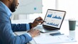 © Zahid - A financial analyst uses a stylus to highlight data on a spreadsheet displayed on a laptop, businessman working on laptop