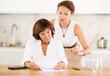 © JackF - Two adult women discuss documents, try to solve financial problems