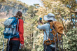 © APstudio - Hikers or explorers family on journey carrying backpack, trekking poles  looks into the distance observing guide trekking and trail exploration holiday ecotourism concept
