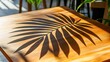 © Turbo - Sunlit wooden table displays a sharply defined palm frond shadow