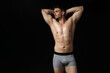 © New Africa - Young man in stylish light grey underwear on black background. Space for text