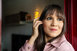 © Jorge - Woman touching hair while thinking and overcoming anxiety at home