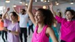 © fotofabrika - Group exercise class in a bright studio with participants enjoying a dance fitness session