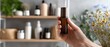© Fernando - Caucasian woman holding aromatherapy essential oil roller bottle indoors Concept of natural skincare, wellness, and selfcare routine