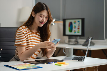 Designer woman thinking ideas strategy about mobile app interface wireframe design with customer breif and color code, User experience concept.