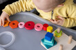 © Vitalina - Baby playing with educational toy, Cognitive skills, Montessori activity. Closeup, selective focus.