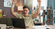 © peopleimages.com - Man, laptop and fist pump with celebration in home with goal, winning or documents for investment. Person, computer and happy for success with achievement, profit or revenue with trading at apartment