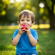 © ayesha - Toddler Eating Red Apple Outdoors Healthy Snack