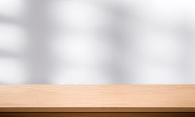 Wall Mural - Wood table top and blurred wall shadow leaves window background can used for display or montage your products