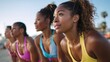 © Gabriel - Focused group of young women in sportswear preparing for a beach workout at sunset, in the summer