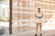 © LIGHTFIELD STUDIOS - Handsome man confidently walking in a stylish urban setting on a bright day