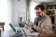 © Migma_Agency - Professional man enjoying coffee while working remotely
