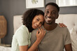 © mavoimages - Young multiracial couple smiling in their bedroom in the morning