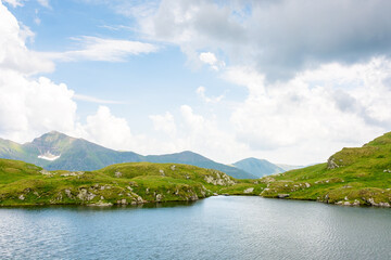 Wall Mural - alpine lake capra in summer. outdoor adventure. cloudy weather. scenery of fagaras ridge. carpathian