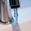 © Photo Verse - A sleek chrome faucet its spigot poised to unleash a cascade of cool blue water met the gaze of a single water droplet poised to embark on its journey down the spout