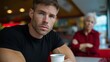 © Postmodern Studio - Superhero in black shirt enjoying coffee at diner