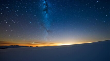 Wall Mural - Night sky with milky way and stars over snow covered landscape with horizon line and warm glow, idyllic nature scene
