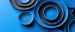 © Kropotkin - A collection of blue and black plates arranged in a circular pattern.