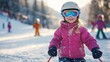© Donna - Smiling young girl in pink jacket and ski goggles enjoying skiing on snowy slope with other children skiing in background on sunny winter day