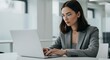 © NicoleS - Photo of Focused Businesswoman Working on Laptop in Modern Office