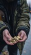 © alexsa - A Moment of Precarious Security: Hands Holding Coins in an Urban Landscape