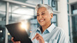 © peopleimages.com - Business, smile and tablet with mature woman in office for administration, planning or research. App, finance and report with happy employee in corporate workplace for review of account information