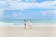 © Aphisara - Couple holding hands running on the beach with vacation or holiday and happy for bonding, smiling and sea with honeymoon, fun and free.