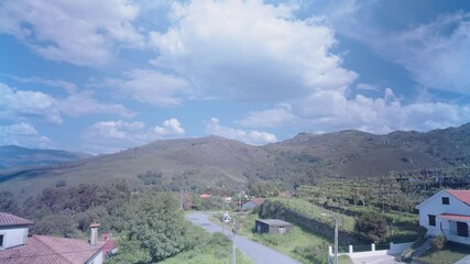 Wall Mural - White clouds moving over the mountains in a blue sky. Time lapse shot.