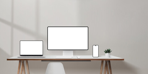 Aufkleber - Bright office desk with laptop, computer monitor, and smartphone mockups, blank wall space for promotional copy