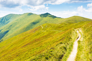 Wall Mural - mountain landscape with path uphill. scenic view. beautiful nature scenery with steep grassy slopes 