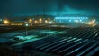 © David - Aerial view of a solar panel farm at night with bright lights illuminating the area and the sky