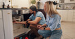 © peopleimages.com - Plumber, man and woman by kitchen sink for pipe, inspection and check for leak for maintenance at house. People, handyman and client with assessment, repair and problem solving for drain at apartment