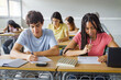 © EFStock - African American Girl writing essay test at college classroom - High school teenager students taking exam