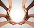 © Puttachat - Conceptual symbol of multiracial human hands of a group people connected together as a supportive symbol that represents a sense of teamwork and togetherness. Symbol and shape created from hands.