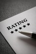 © Wan - A five-star rating form with a pen placed on a textured surface, symbolizing evaluation and feedback.