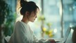 © Evodigger - Confident businesswoman sits at desk working with laptop in office,smiling,business concept.
