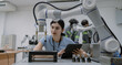 © Nassorn - Hispanic engineer woman working on AI technology in robotics electronics engineering laboratory. University students' research project is programming robot machine with intelligent mechanical control