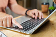 © DG PhotoStock - Asian woman is pressing on enter button key on laptop computer.