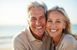 © Maryna - Cheerful senior couple with bright smiles showing perfect white teeth. Happy elderly man woman portrait. Healthcare dentistry concept. Healthy lifestyle. Beautiful people on beach, seaside background.