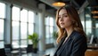 © NAD SANG PAP - Professional Woman in Modern Office Focused Expression Business Environment Indoor View Blurry Background