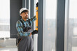 © Serhii - Arab engineer using spirit level on construction site window frame