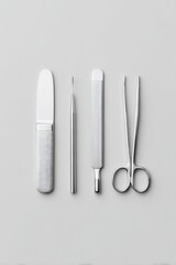 Wall Mural - minimalistic composition features surgical instruments arranged in orderly fashion on clean light ba